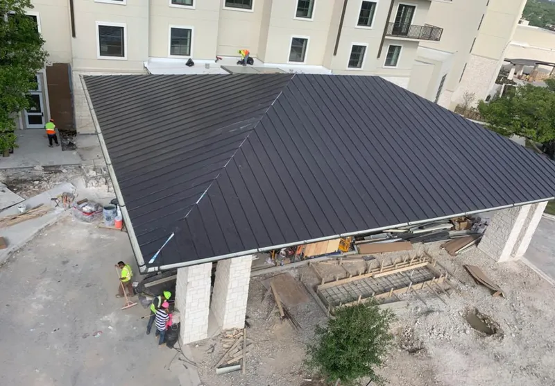 Metal roofing installation team working on a commercial building in Arlington